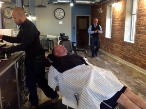 Jimmy's Barbershop, Eric Castro left, Kerry Kulp, in chair, Jimmy Moyer, right.